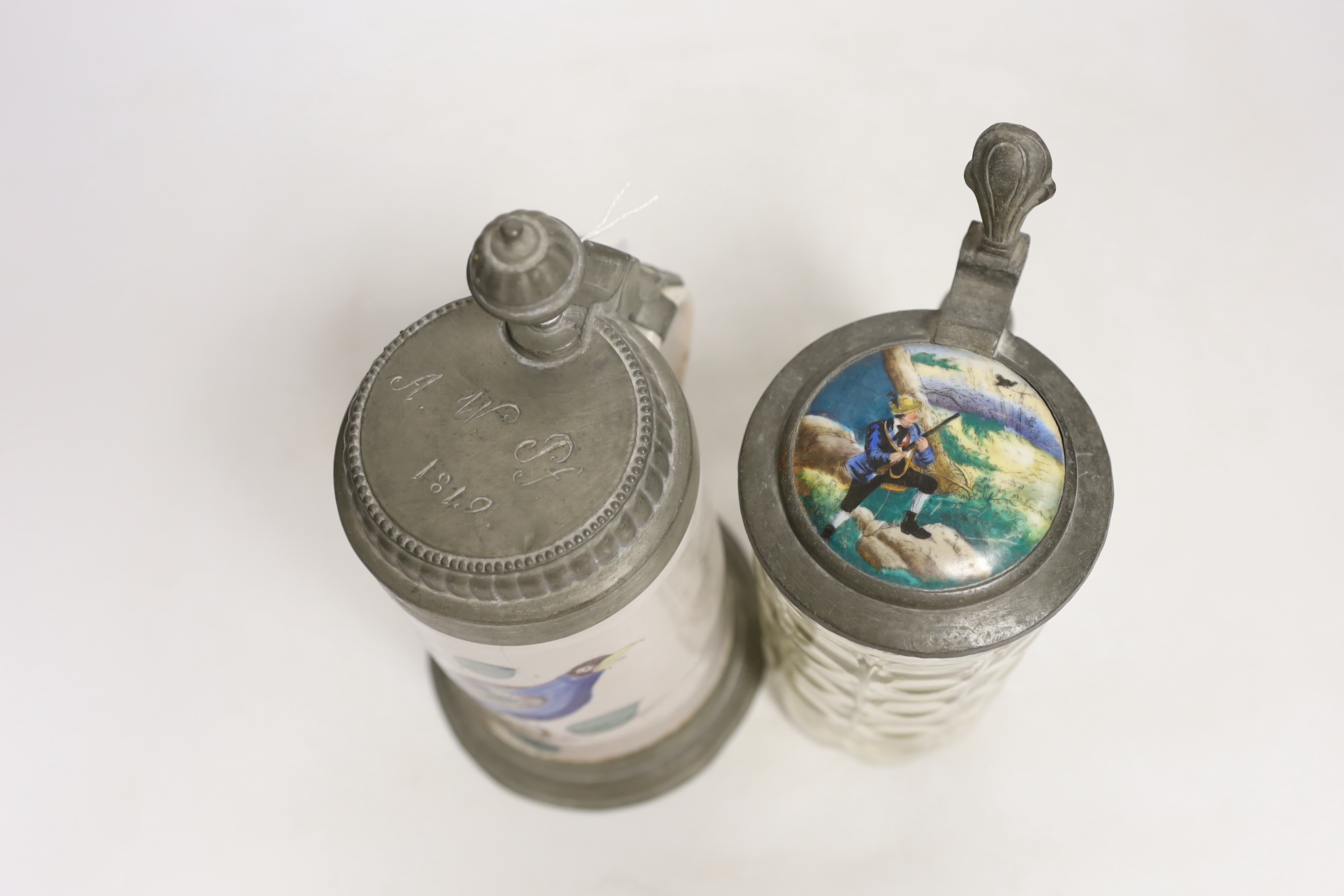Two German steins including a faience example, together with a glass inkwell, largest 24cm high